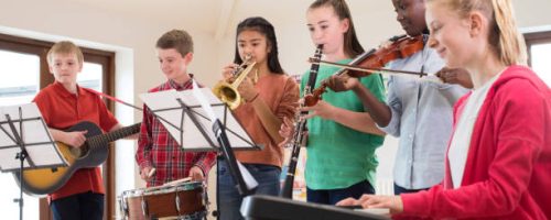 High School Students Playing In School Orchestra Together